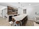 Bar features wood accent wall, wine storage, an island with seating, and a tv at 3215 Bellamy Ridge Dr, Apex, NC 27523