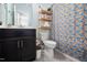 Well-lit bathroom with dark cabinets and a shower featuring a whimsical banana-themed curtain at 3215 Bellamy Ridge Dr, Apex, NC 27523