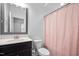 Functional bathroom with a vanity, toilet, and shower with a pink, patterned curtain at 3215 Bellamy Ridge Dr, Apex, NC 27523