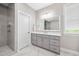 Bathroom showcasing glass enclosed shower, tile floors, large vanity, and decorative fixtures at 3215 Bellamy Ridge Dr, Apex, NC 27523