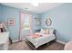 Bright bedroom boasts a large window, soft hues, and decorative wall accents at 3215 Bellamy Ridge Dr, Apex, NC 27523