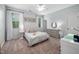 Light-filled bedroom offers neutral paint, ceiling fan, and ample natural light at 3215 Bellamy Ridge Dr, Apex, NC 27523