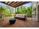Relaxing outdoor deck with a modern sofa and cozy fire pit, perfect for enjoying the scenery at 3215 Bellamy Ridge Dr, Apex, NC 27523
