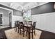 Formal dining room with coffered ceilings, wainscoting, sophisticated lighting, and large windows at 3215 Bellamy Ridge Dr, Apex, NC 27523