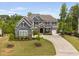 Beautiful two-story home featuring a well-manicured lawn, a symmetrical facade, and a wide driveway at 3215 Bellamy Ridge Dr, Apex, NC 27523