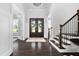 Grand foyer featuring hardwood floors, a staircase, and a double door entry with wreath at 3215 Bellamy Ridge Dr, Apex, NC 27523