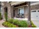 Charming front porch with rocking chairs, stone accents, and manicured landscaping at 3215 Bellamy Ridge Dr, Apex, NC 27523