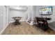 This finished game room features wood floors, stairs, and a video game console with an arcade game and foosball table at 3215 Bellamy Ridge Dr, Apex, NC 27523