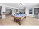 This game room features a billiards table and bar area with natural lighting, perfect for entertaining guests at 3215 Bellamy Ridge Dr, Apex, NC 27523