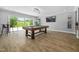 Entertain in this expansive game room with a billiards table and sliding doors opening to scenic outdoor views at 3215 Bellamy Ridge Dr, Apex, NC 27523