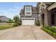 Attached two-car garage featuring stone accents and a modern white door, complemented by landscaped surroundings at 3215 Bellamy Ridge Dr, Apex, NC 27523