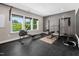 This home gym has a view of the outside and is fully equipped with a weight rack, rowing machine, and rubber flooring at 3215 Bellamy Ridge Dr, Apex, NC 27523