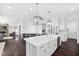 Open-concept kitchen with a large island, stainless steel appliances, and dark hardwood floors at 3215 Bellamy Ridge Dr, Apex, NC 27523