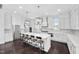 Bright, spacious kitchen with a large center island, breakfast bar, white cabinets, and stainless appliances at 3215 Bellamy Ridge Dr, Apex, NC 27523