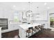 Well-lit kitchen with a large island, breakfast bar, stainless steel appliances, and white cabinetry at 3215 Bellamy Ridge Dr, Apex, NC 27523