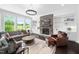 Comfortable living room features a stone fireplace, custom built-ins, plush seating, and hardwood floors at 3215 Bellamy Ridge Dr, Apex, NC 27523