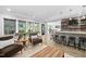 This spacious living room features a bar, comfortable seating, natural light, and access to an outdoor patio area at 3215 Bellamy Ridge Dr, Apex, NC 27523