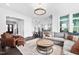 Expansive living room with an open floor plan, neutral colors, plush seating, and dark hardwood floors at 3215 Bellamy Ridge Dr, Apex, NC 27523