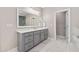 Main bathroom featuring a gray vanity with double sinks, white countertop, and marble floors at 3215 Bellamy Ridge Dr, Apex, NC 27523