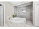 Elegant main bathroom with soaking tub, glass shower, and marble tile surround at 3215 Bellamy Ridge Dr, Apex, NC 27523