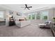 This spacious main bedroom features lots of natural light, a ceiling fan, and plush carpeting at 3215 Bellamy Ridge Dr, Apex, NC 27523
