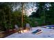 Outdoor patio with Adirondack chairs, a cornhole setup, and vineyard views at 3215 Bellamy Ridge Dr, Apex, NC 27523