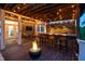 Covered outdoor kitchen with bar seating, a grill, and a cozy fire pit on the deck at 3215 Bellamy Ridge Dr, Apex, NC 27523