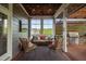 Cozy screened patio with comfortable seating and an outdoor kitchen, perfect for entertaining at 3215 Bellamy Ridge Dr, Apex, NC 27523