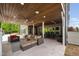 Expansive patio with comfortable outdoor seating, bar stools and views of the landscaped yard at 3215 Bellamy Ridge Dr, Apex, NC 27523