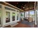 Beautiful screened patio features comfortable seating, a fan, and views of the backyard at 3215 Bellamy Ridge Dr, Apex, NC 27523