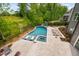 Aerial view of the backyard featuring a luxurious pool with lounge chairs, hot tub, and waterslide at 3215 Bellamy Ridge Dr, Apex, NC 27523