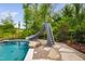 Pool with a slide, perfect for Gathering fun, nestled within lush, natural surroundings at 3215 Bellamy Ridge Dr, Apex, NC 27523