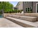 Tiered travertine steps lead down to the pool area, offering a stylish transition at 3215 Bellamy Ridge Dr, Apex, NC 27523