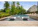 Resort-style swimming pool with lounge chairs, slide, and lush landscaping, perfect for relaxation at 3215 Bellamy Ridge Dr, Apex, NC 27523