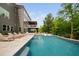 Expansive swimming pool with lounge chairs, a slide, and lush landscaping, ideal for outdoor enjoyment at 3215 Bellamy Ridge Dr, Apex, NC 27523