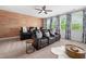 Entertainment room features theater seating, wood accent wall, and natural light at 3215 Bellamy Ridge Dr, Apex, NC 27523