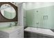 Bathroom featuring a modern vanity, round mirror, and separate shower and jetted tub at 323 W Main St # C, Durham, NC 27701