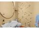 Cozy half bathroom features patterned wall and simple sink and toilet at 323 W Main St # C, Durham, NC 27701