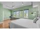 Bedroom with hardwood floors, neutral green walls, and work space under bright windows at 323 W Main St # C, Durham, NC 27701