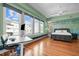 Bright bedroom with hardwood floors, large windows, and a modern ceiling fan at 323 W Main St # C, Durham, NC 27701