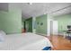 Spacious bedroom boasts hardwood floors, green walls, and an attached door for convenience at 323 W Main St # C, Durham, NC 27701