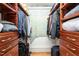 Spacious walk-in closet offers ample storage with custom shelving and hardwood floors at 323 W Main St # C, Durham, NC 27701