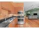 Modern kitchen features stainless appliances, dark countertops, and orange cabinets at 323 W Main St # C, Durham, NC 27701