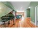 Spacious living room features a grand piano and flows into the adjacent sitting area at 323 W Main St # C, Durham, NC 27701