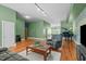 Large living room with lots of space, hardwood floors, and a piano at 323 W Main St # C, Durham, NC 27701