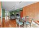 View of open living space with dining area, couch and piano with hardwood floors at 323 W Main St # C, Durham, NC 27701