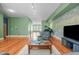 Living room featuring a piano and large open spaces with hardwood floors at 323 W Main St # C, Durham, NC 27701