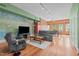 Cozy living room with hardwood floors, comfortable seating, and an entertainment center at 323 W Main St # C, Durham, NC 27701