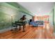 Open-concept living room with hardwood floors, exposed brick, and natural light at 323 W Main St # C, Durham, NC 27701