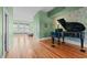 Living room featuring a piano with hardwood floors at 323 W Main St # C, Durham, NC 27701